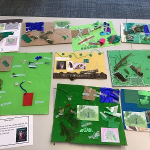 students and their artwork on a table